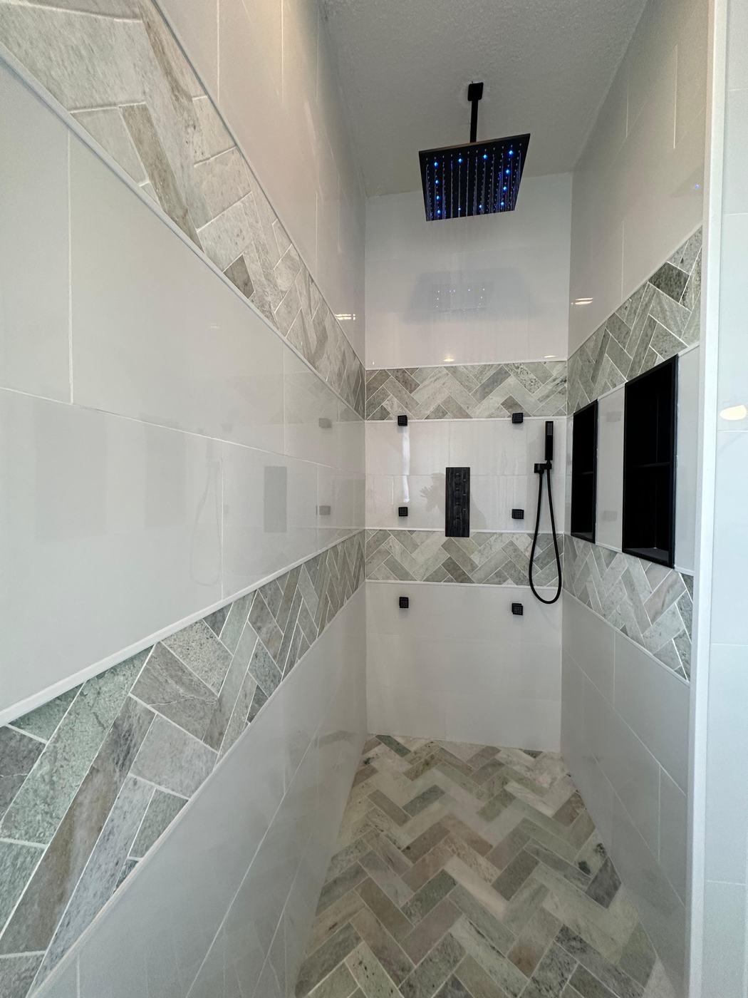 Shower with rain head and herringbone tile